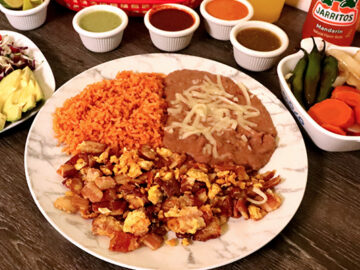 eggs with bacon with a side of rice and beans
